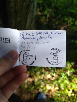 A small cache logbook with dates written by finders and two round rubber stamps, 1reko2 with a cartoon face and 1Reka2 with a bunny